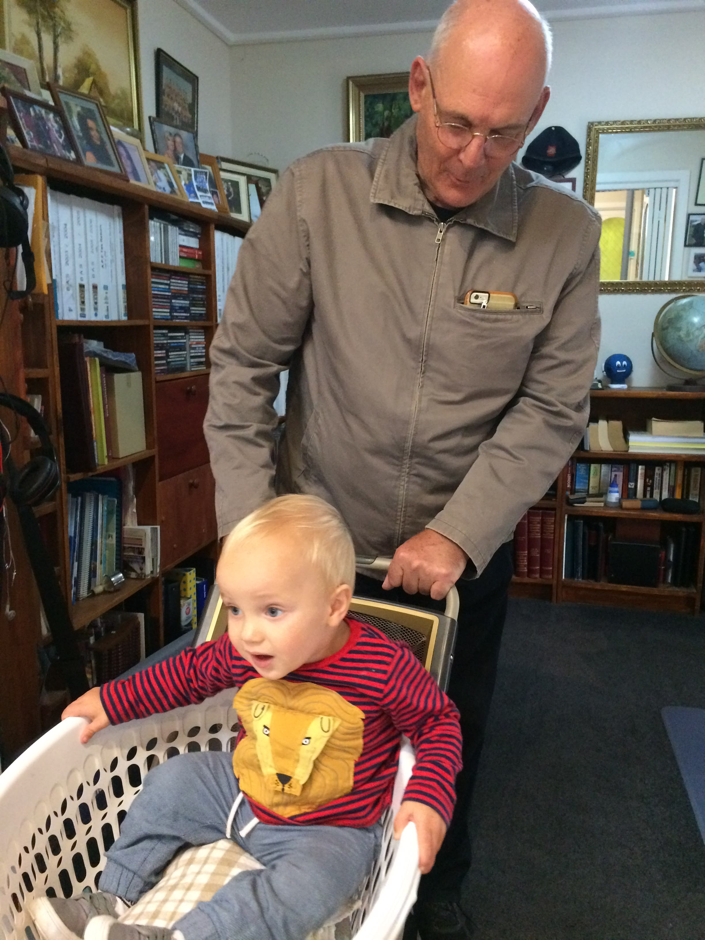 Ollie resting in a basket while Martin is beside him