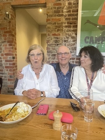 Aunty Dianne seated with two relatives at a family meal