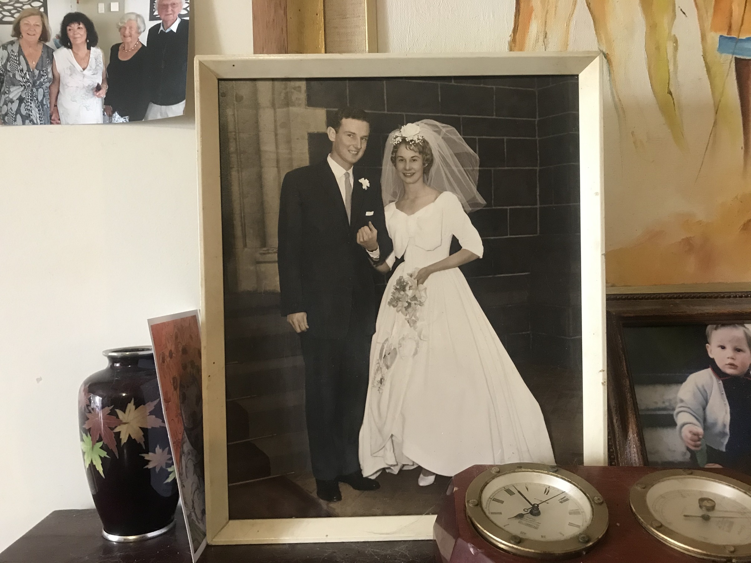 A wedding photograph displayed with smaller family pictures