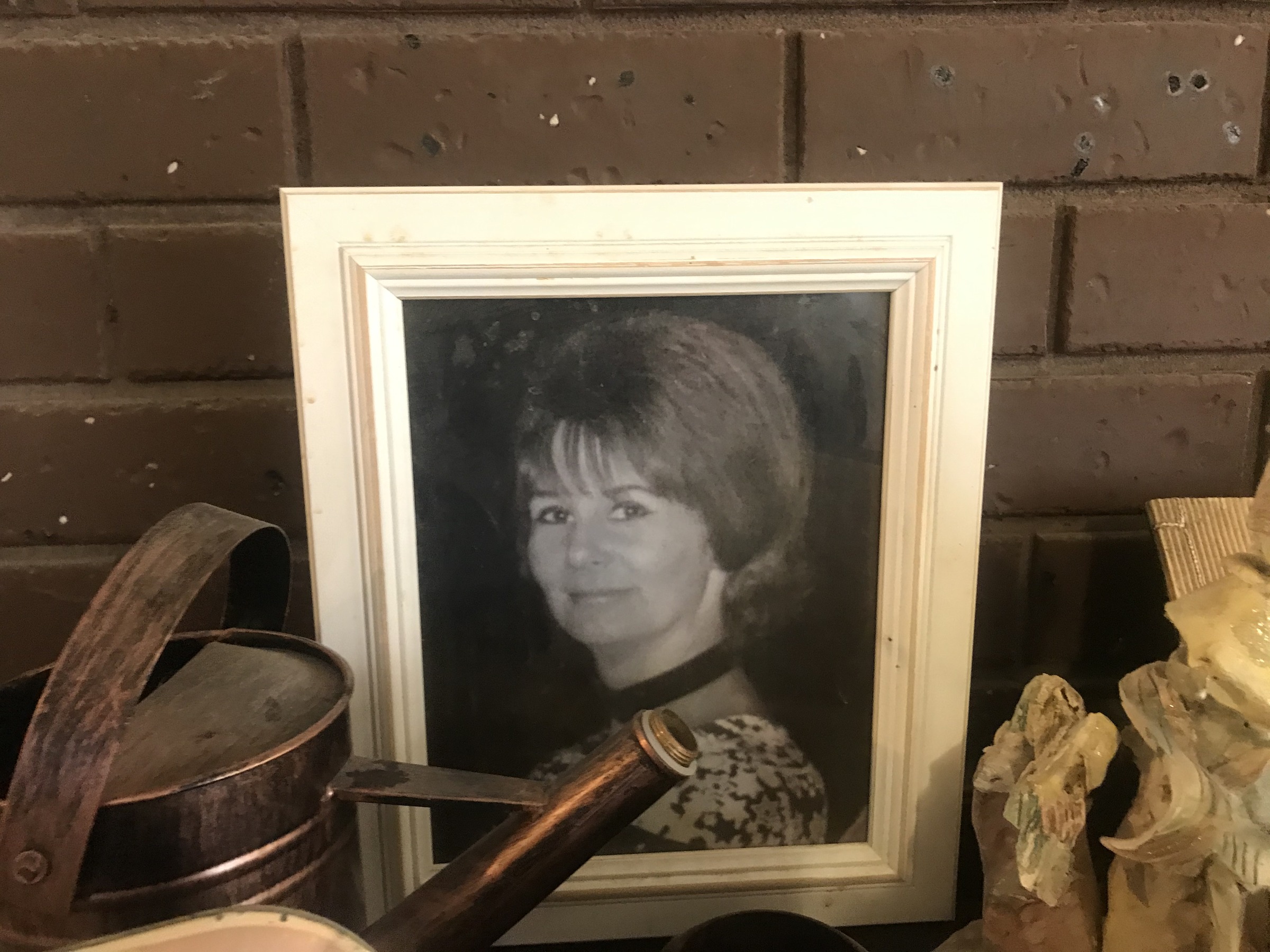 A portrait of a woman displayed in a frame at Ian’s home