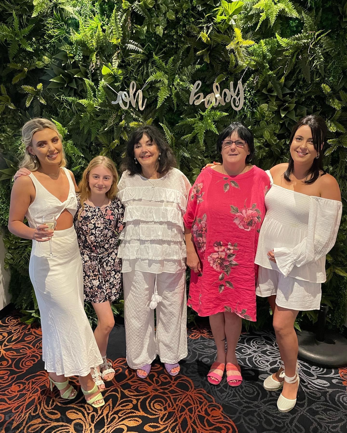 Four women standing together for a family portrait
