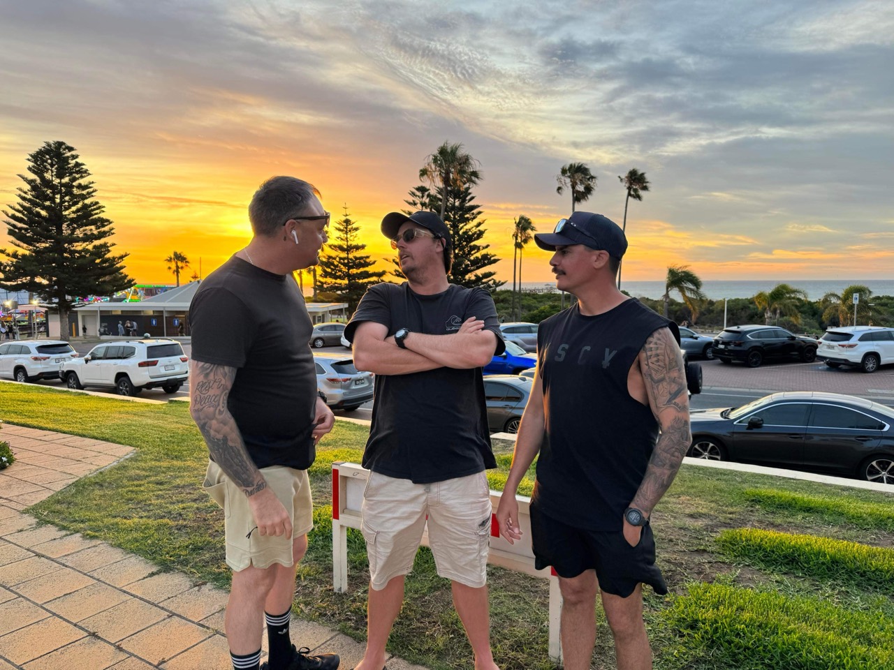 Lawrence talking with friends at sunset