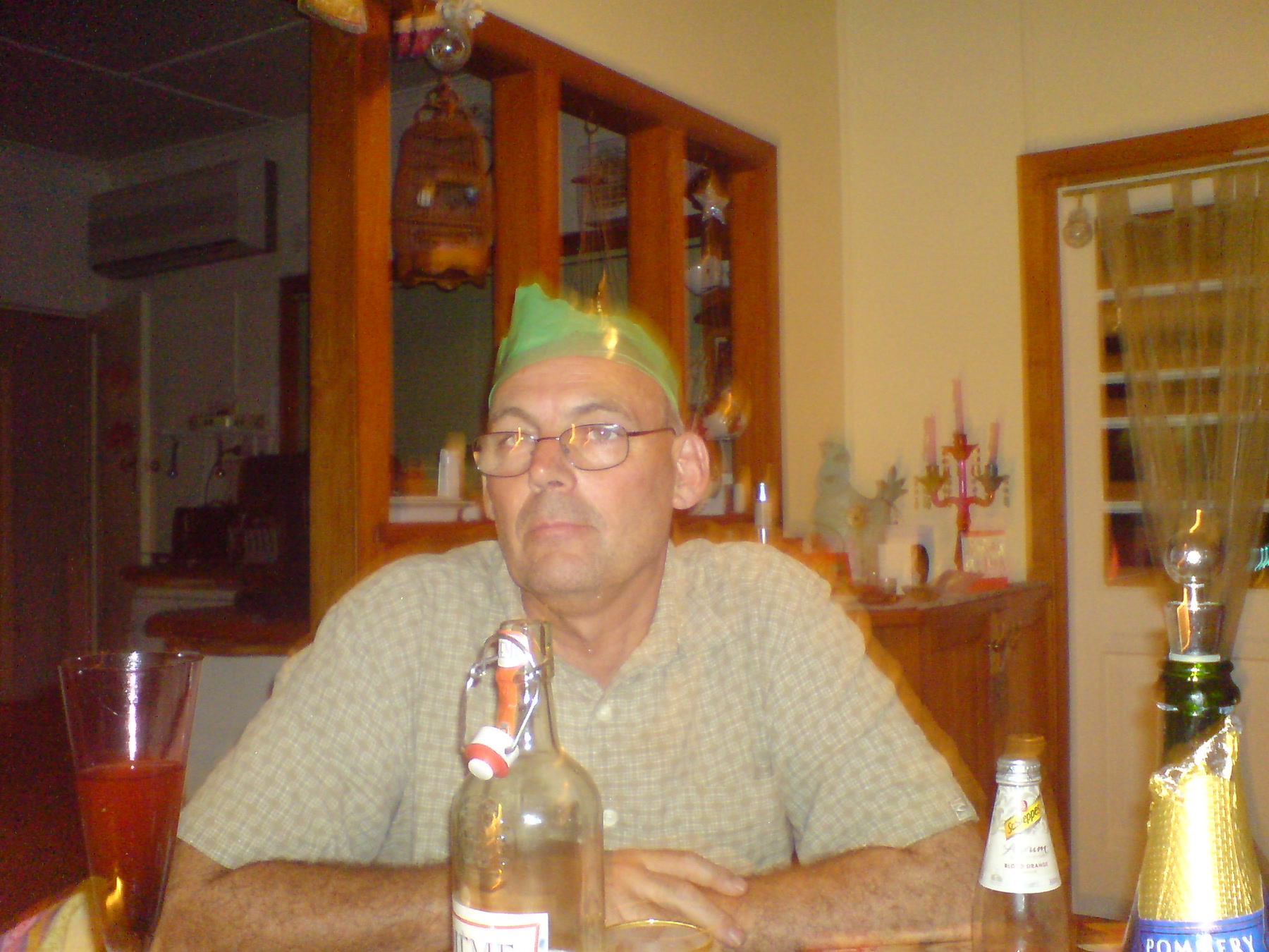 Martin seated at a table wearing a green novelty hat