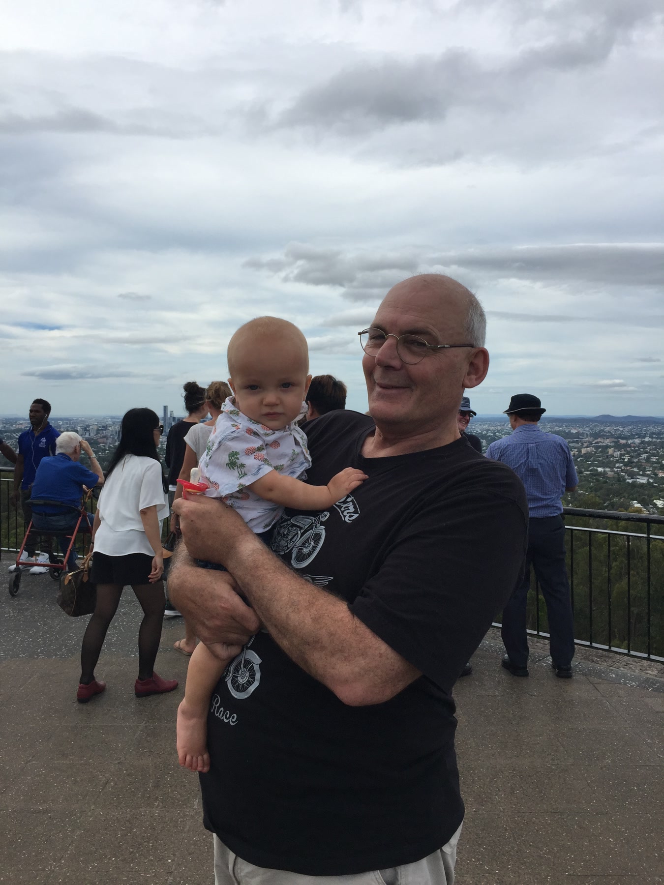 Martin holding an infant at Mount Coot-tha
