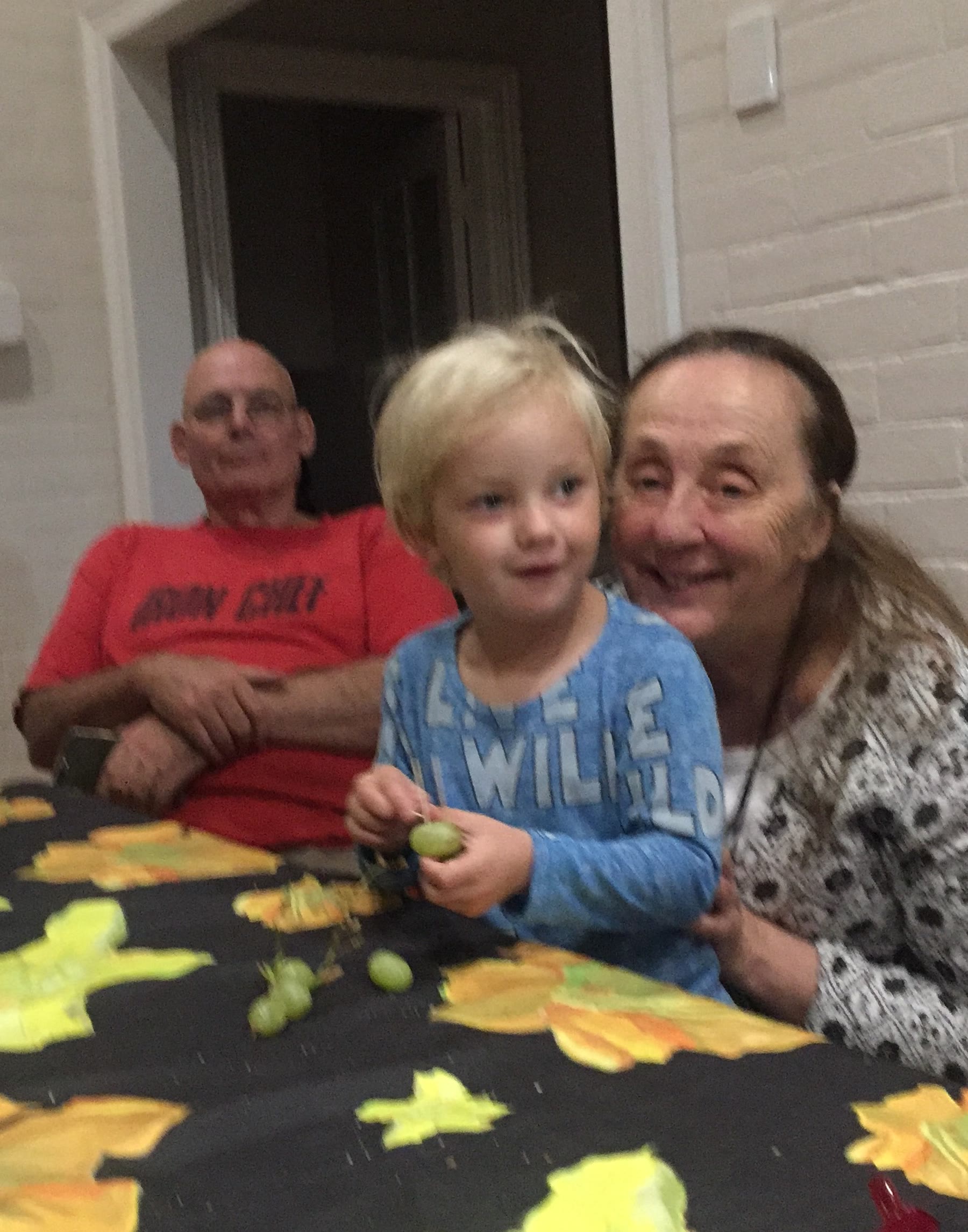 Martin at an indoor table with an adult and a child