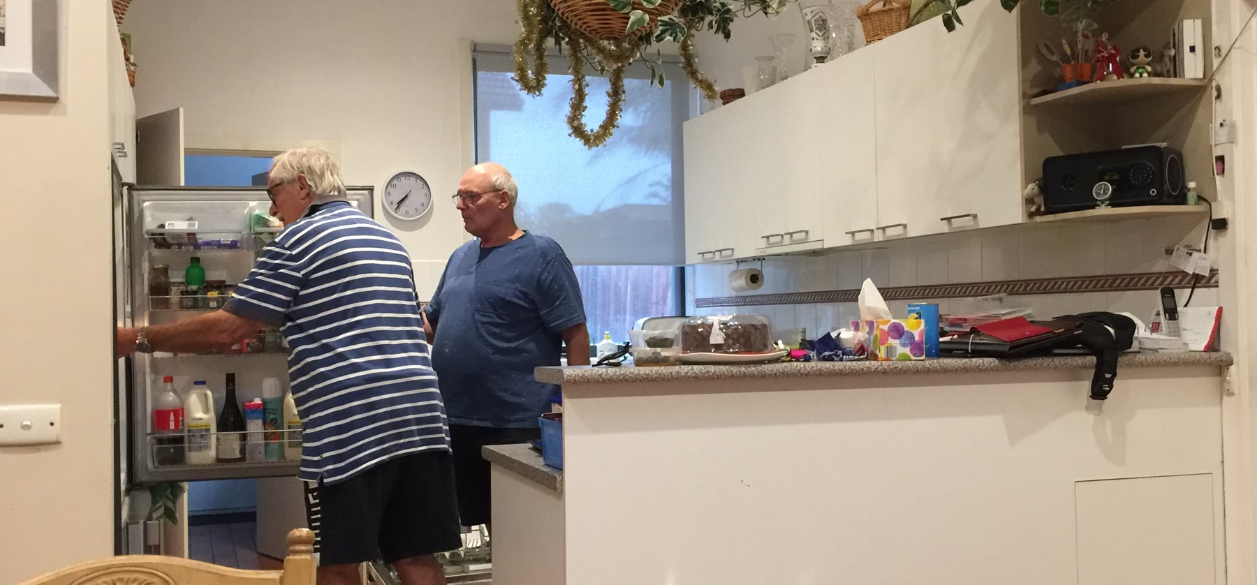 Martin and an unidentified companion standing together in a kitchen