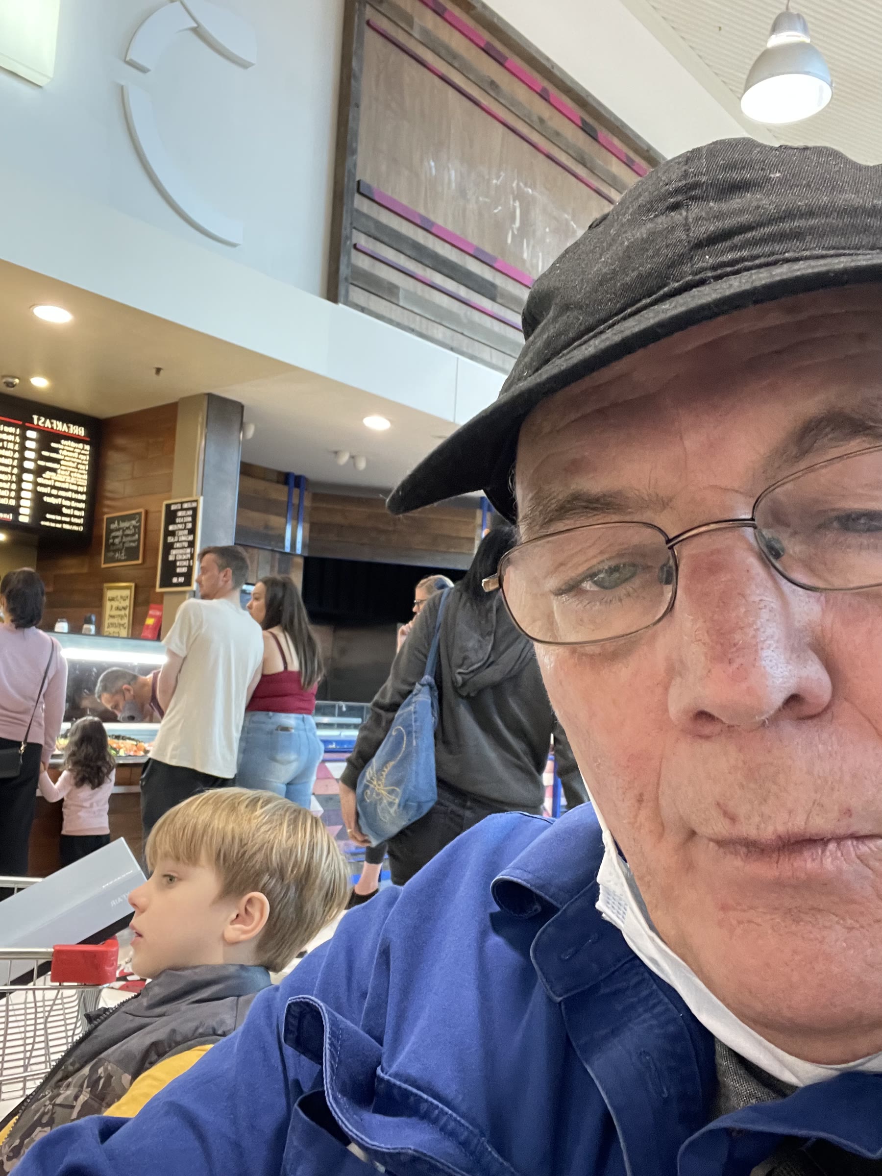 Martin taking a close selfie with Olly at a food counter
