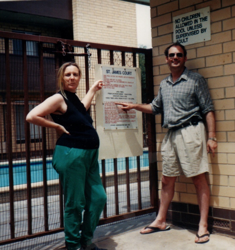 Martin and Claire beside the pool gate and a St. James Court notice